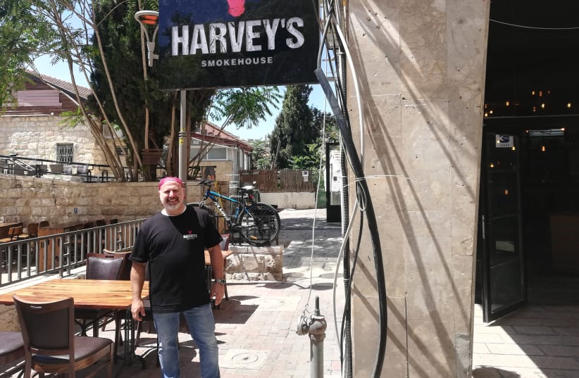 Harvey Sandler stands in front of the new location of Harvey's Smokehouse. (photo credit: ZEV STUB)