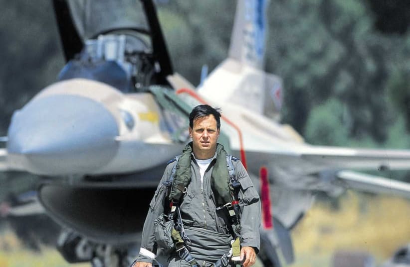 Portait of Ilan Ramon standing in front of an F16 aircraft.  (photo credit: FLASH90)