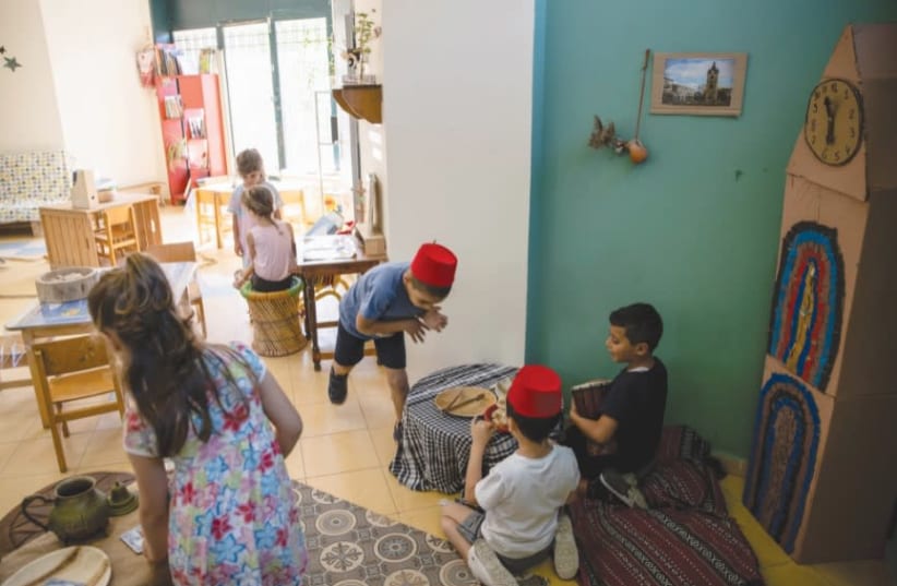 CHILDREN PLAY in a classroom at Hand in Hand, a mixed Jewish-Arab kindergarten, in Jaffa. (photo credit: RONEN ZVULUN/REUTERS)
