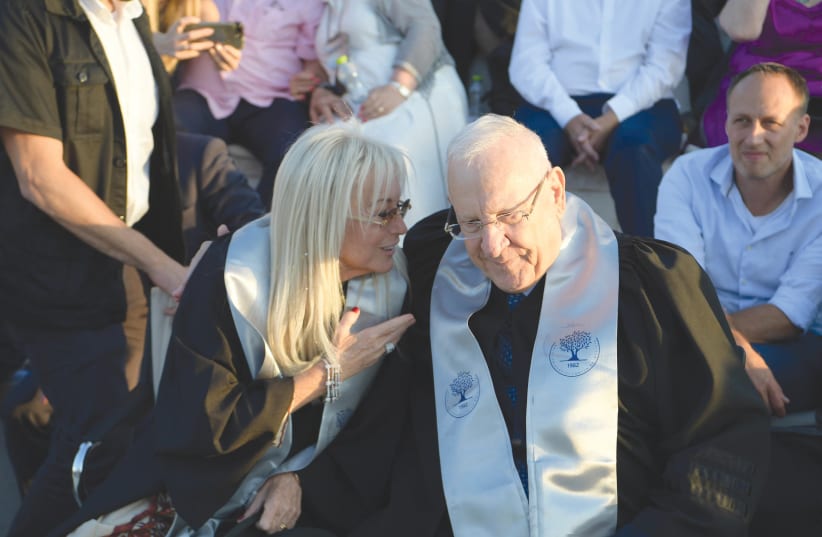 PRESIDENT REUVEN RIVLIN and Dr. Miriam Adelson engage in a doctoral tête-à-tête at Ariel University. (photo credit: AMOS BEN-GERSHOM/GPO)