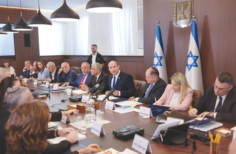 PRIME MINISTER Naftali Bennett chairs the first weekly cabinet meeting of his new government on Sunday. (photo credit: EMMANUEL DUNAND/REUTERS)