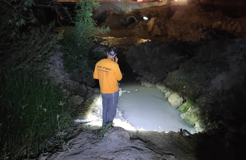 A ZAKA volunteer inspects a recently-formed reservoir near Beit Shemesh where a 14-year-old child was found dead. June 25, 2021. (photo credit: ZAKA RESCUE AND RECOVERY ORGANIZATION)