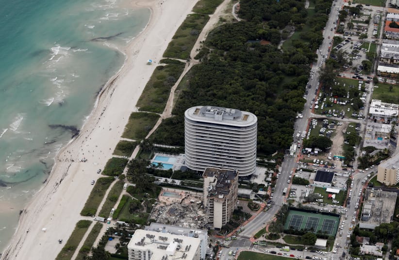 An aerial view showing a partially collapsed building in Surfside near Miami Beach (photo credit: MARCO BELLO/REUTERS)