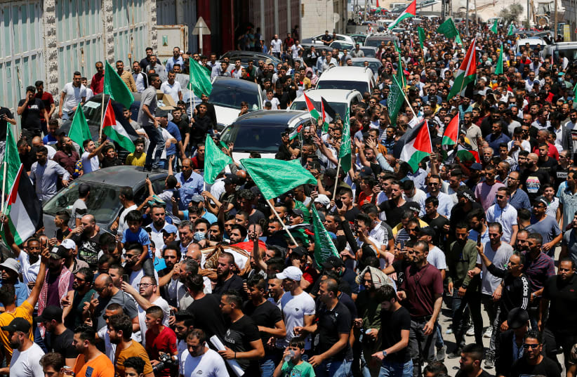People attend the funeral of Palestinian critic Nizar Banat, who died after being arrested by Palestinians Authority's security forces, in Hebron (photo credit: MUSSA QAWASMA/REUTERS)