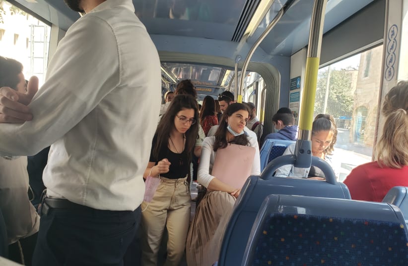 People riding the Jerusalem light rail on Sunday, June 27, three days after the indoor mask mandate was reinstated (photo credit: BEN BARUCH)