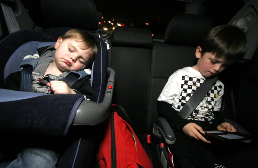Children in the car in booster seats (photo credit: FLICKR)