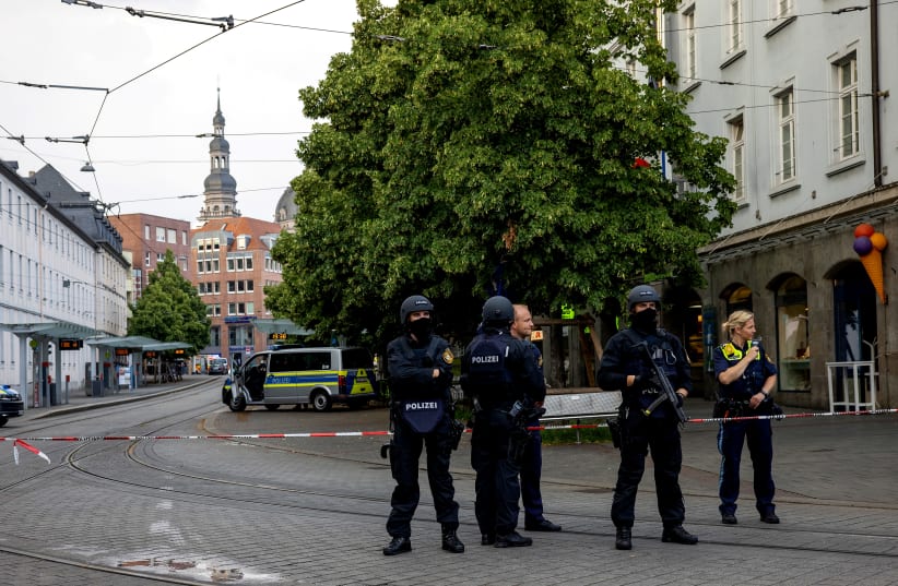Police secures the area in the German town of Wuerzburg, Germany, June 25, 2021, during a "major operation" in which police arrested a suspect after local media had earlier reported multiple stabbings. (photo credit: REUTERS/HEIKO BECKER)