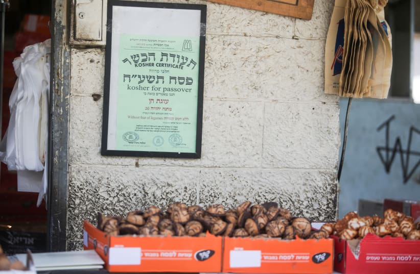 A ‘KOSHER FOR Passover’ poster at a stand in Mahane Yehuda in Jerusalem. (photo credit: MARC ISRAEL SELLEM)