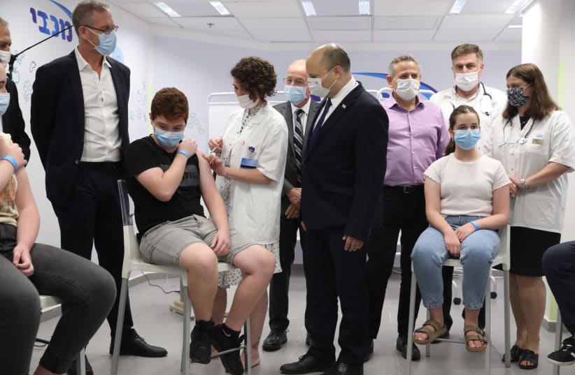 Prime Minister Naftali Bennett visiting a vaccination center in Holon, June 29, 2021.  (photo credit: MARC ISRAEL SELLEM/THE JERUSALEM POST)