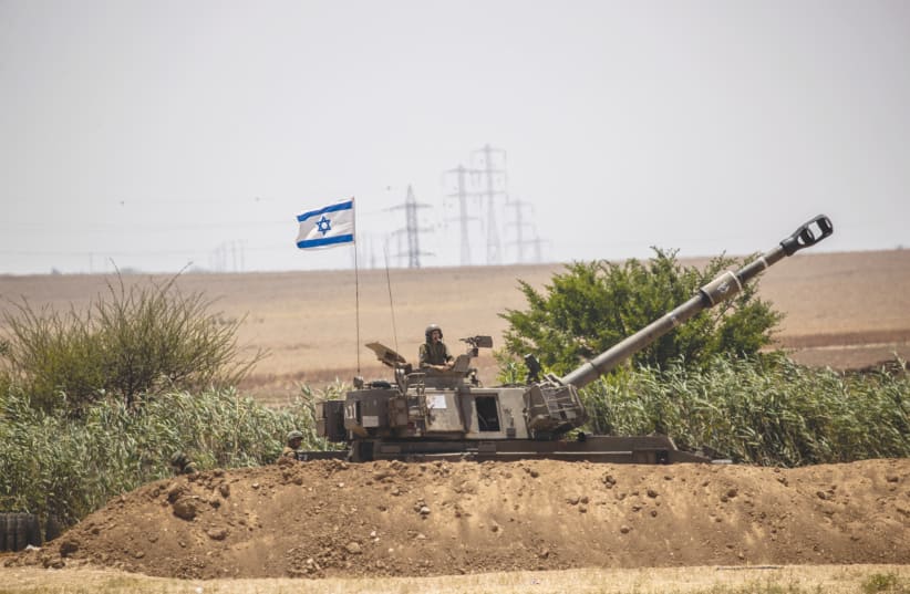 The IDF Artillery Corps is seen firing into Gaza, last month. (photo credit: YONATAN SINDEL/FLASH90)