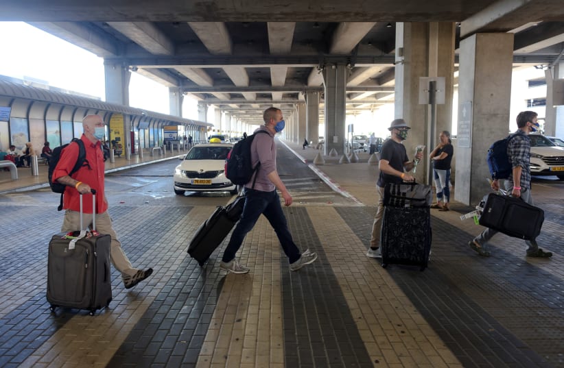 ourists walk at the Ben Gurion International Airport after entering Israel by plane, as coronavirus disease (COVID-19) restrictions ease, in Lod, near Tel Aviv, Israel (photo credit: RONEN ZVULUN/ REURERS)