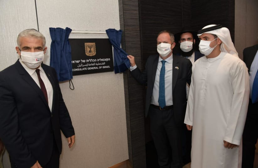 Foreign Minister Yair Lapid is seen unveiling the sign at the Israeli Consulate in Dubai, on June 30, 2021. (photo credit: SHLOMI AMSALEM/GPO)