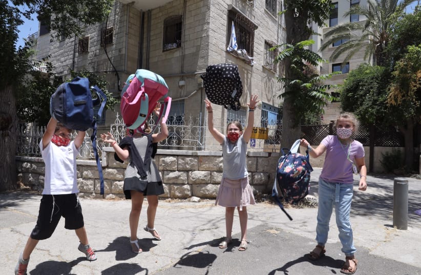 Children are seen celebrating the last day of school in Jerusalem, on June 30, 2021. (photo credit: MARC ISRAEL SELLEM/THE JERUSALEM POST)