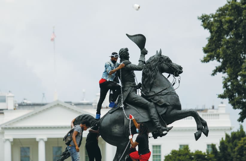 PROTESTERS ATTACH a chain to a statue of Andrew Jackson in front of the White House in Washington last summer. (photo credit: TOM BRENNER/REUTERS)