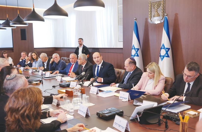 Prime Minister Naftali Bennett in a cabinet meeting. (photo credit: EMMANUEL DUNAND/REUTERS)