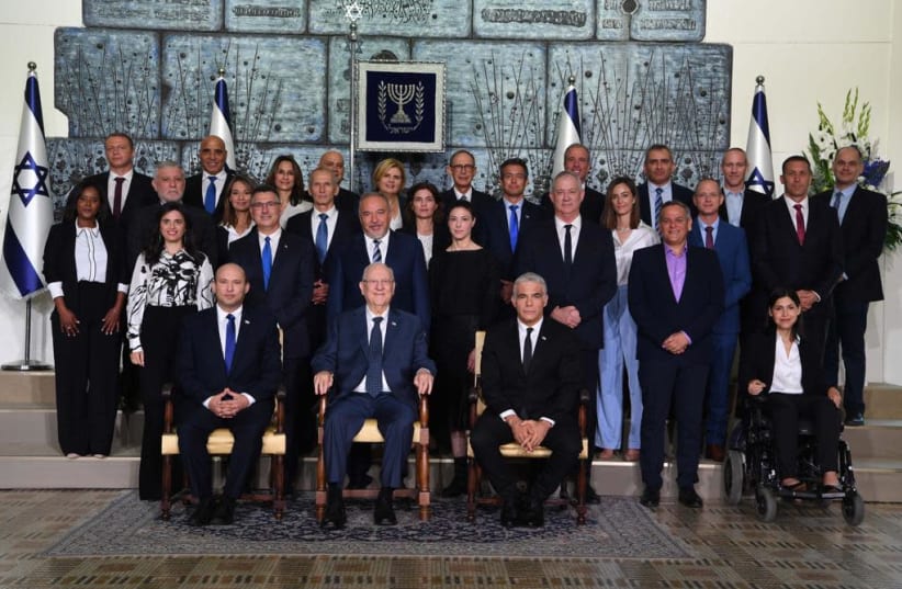 Prime Minister Naftali Bennett and his new government pose for a photograph at the President’s Residence on June 14. Front row (from left): Bennett, President Reuven Rivlin, Alternate Prime Minister and Foreign Minister Yair Lapid. First row: Interior Minister Ayelet Shaked, Justice Minister Gideon  (photo credit: AVI OHAYON - GPO)