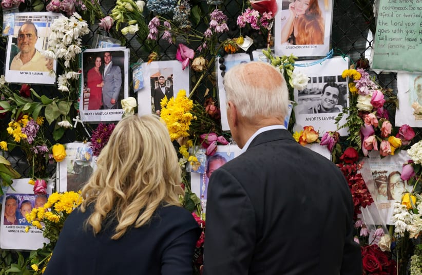 US President Joe Biden and first lady Jill Biden visit a memorial put in place for the victims of the building collapse in Surfside, in Tent city area, Surfside, Florida US, July 1, 2021. (photo credit: REUTERS/KEVIN LAMARQUE)