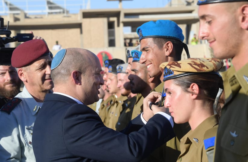 Prime Minister Naftali Bennett participates in graduating ceremony for IDF officers. (photo credit: AMOS BEN GERSHOM, GPO)
