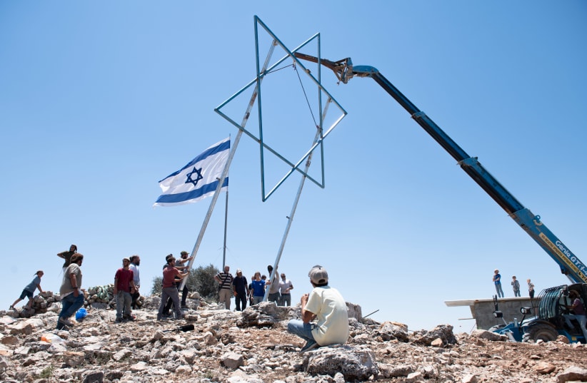 Jews placed a Star of David at the illegal Israeli outpost of Evyatar, before its evacuation as part of a deal with the government, July 2, 2021. (photo credit: SRAYA DIAMANT/FLASH90)
