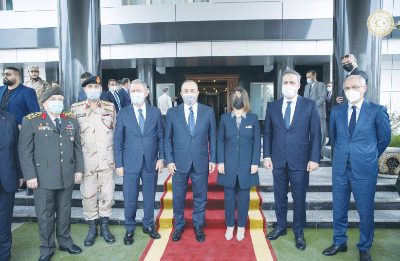 TURKISH FOREIGN Minister Mevlut Cavusoglu, Libyan Foreign Minister Najla el-Mangoush and others meet in Tripoli in May. (photo credit: REUTERS)