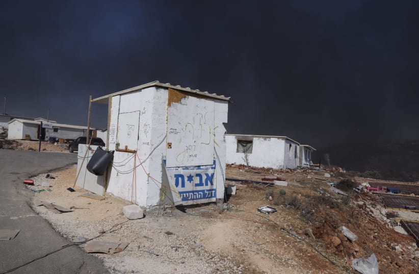 Smoke from a Palestinian tire fire turned the blue sky black at the Evyatar outpost. (photo credit: MARC ISRAEL SELLEM)