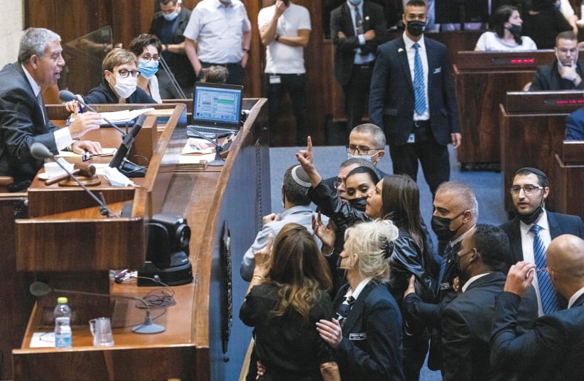 MEMBERS OF the opposition react during a discussion on a law regarding work leave without payment, during a plenum session in the Knesset last week. (photo credit: YONATAN SINDEL/FLASH90)