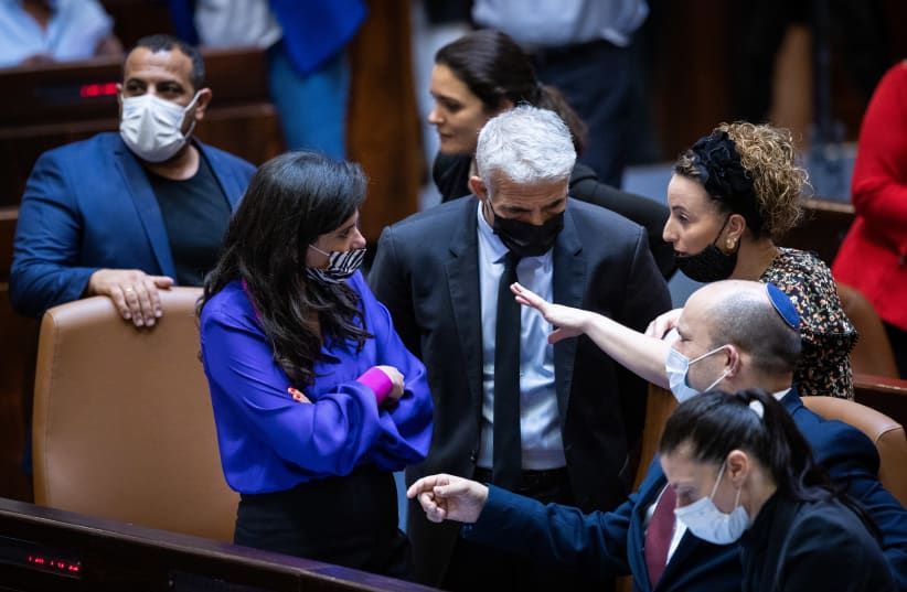 Prime Minister Naftali Bennett and Foreign Minister Yair Lapid with Interior Minister Ayelet Shaked, Transport Minister Merav Michaeli, and Yamina MK Idit Silman ahead of the Citizenship Law vote, July 6, 2021 (photo credit: YONATAN SINDEL/FLASH 90)
