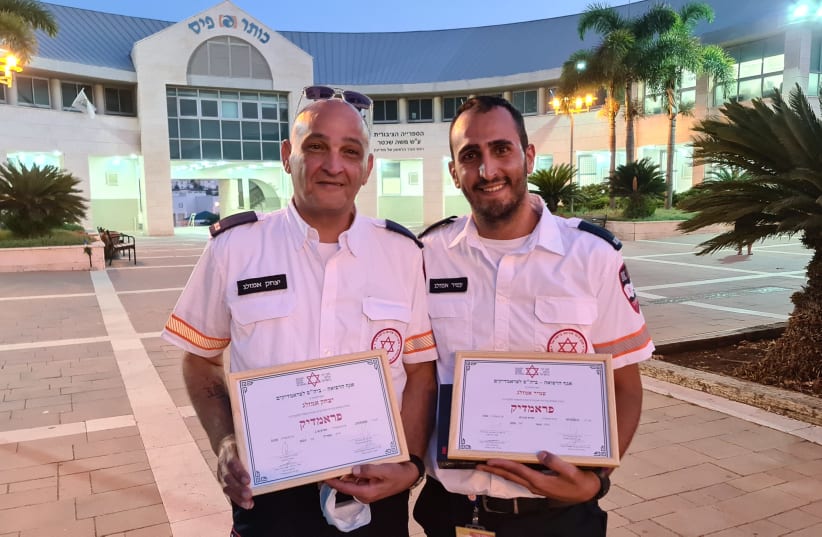 Yitzhak and Amir Amzaleg at the graduation ceremony for the MDA paramedics course. (photo credit: MAGEN DAVID ADOM ISRAEL)