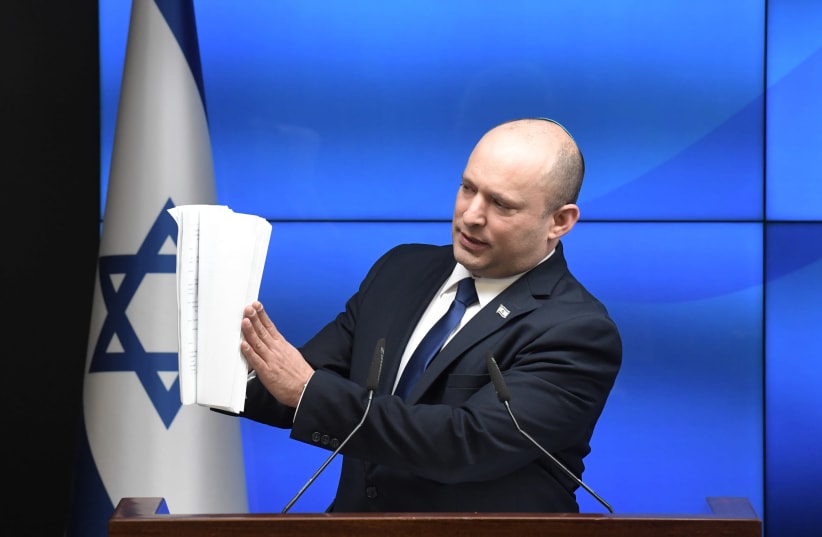 Prime Minister Naftali Bennett is seen gesturing at paper, on July 6, 2021. (photo credit: KOBI GIDEON/GPO)