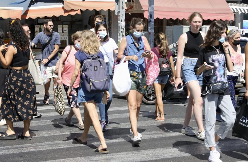 Israelis walk the streets of Tel Aviv, July 6, 2021. (photo credit: MARC ISRAEL SELLEM)