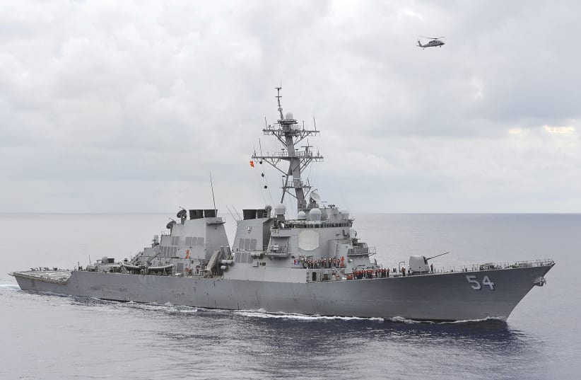 US NAVY guided-missile destroyer patrols in the Philippine Sea. The destroyer sailed within 12 nautical miles of an island claimed by China and two other states in the South China Sea in 2016 to counter efforts to limit freedom of navigation, the Pentagon said.  (photo credit: REUTERS)