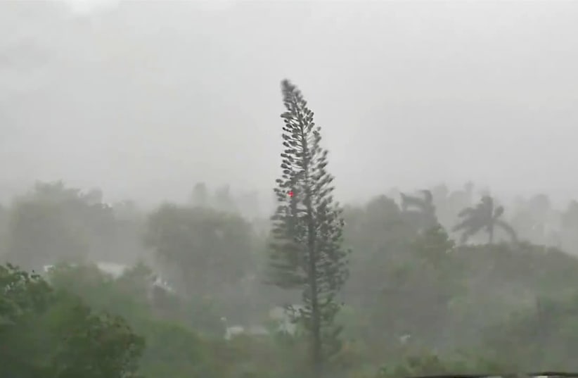 Trees sway amid rainfall and wind as Tropical Storm Elsa strengthened into a Category 1 hurricane as it makes its way through Key West, Florida, US, July 6, 2021, in this still image from video obtained via social media. (photo credit: NWS KEY WEST VIA REUTERS)