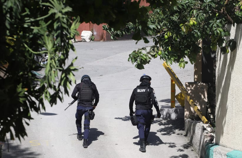 Police officers walk near the private residence of Haiti's President Jovenel Moise after he was shot dead by gunmen with assault rifles, in Port-au-Prince, Haiti July 7, 2021.  (photo credit: REUTERS/ESTAILOVE ST-VAL)