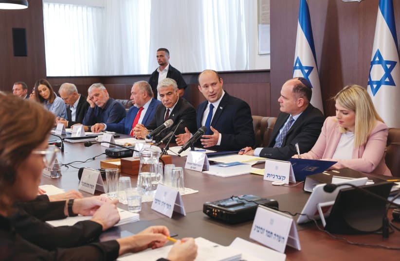 PRIME MINISTER Naftali Bennett speaks as he chairs the first weekly cabinet meeting of his new government in Jerusalem last month. (photo credit: EMMANUEL DUNAND/REUTERS)