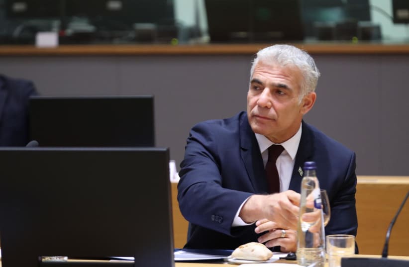 Israel's Foreign Minister Yair Lapid is seen speaking to European Union foreign ministers in Brussels, Belgium, on July 12, 2021. (photo credit: EUROPEAN UNION)