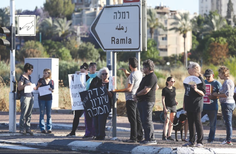 Jews and Arabs protest together for calm and coexistence in Lod, following a night of heavy rioting by Arab residents, in May. (photo credit: YOSSI ALONI/FLASH90)