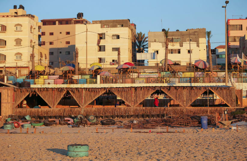 The environment-friendly beachfront cafe built of tonnes of solid waste is seen from the beach in Gaza July 8, 2021 (photo credit: REUTERS/ IBRAHEEM ABU MUSTAFA)