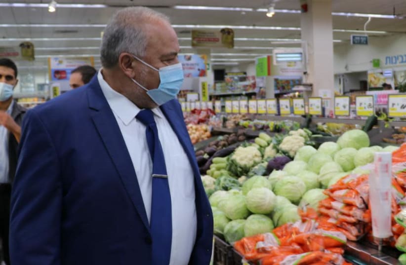 Finance Minister Avigdor Liberman checks food prices at a Jerusalem supermarket. (photo credit: Courtesy)