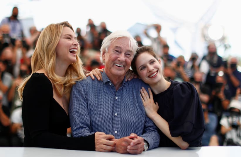 Paul Verhoeven at Cannes Film Festival, with two actresses from his film, Benedetta (photo credit: REUTERS)