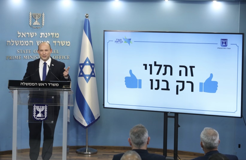 Prime Minister Naftali Bennett prepares to adress the nation at a press conference regarding the coronavirus pandemic, July 14, 2021. (photo credit: MARC ISRAEL SELLEM/THE JERUSALEM POST)