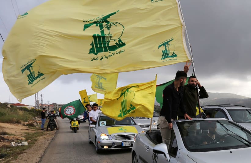 WAVING THE Hezbollah flag in Marjayoun, Lebanon. (photo credit: AZIZ TAHER/REUTERS)