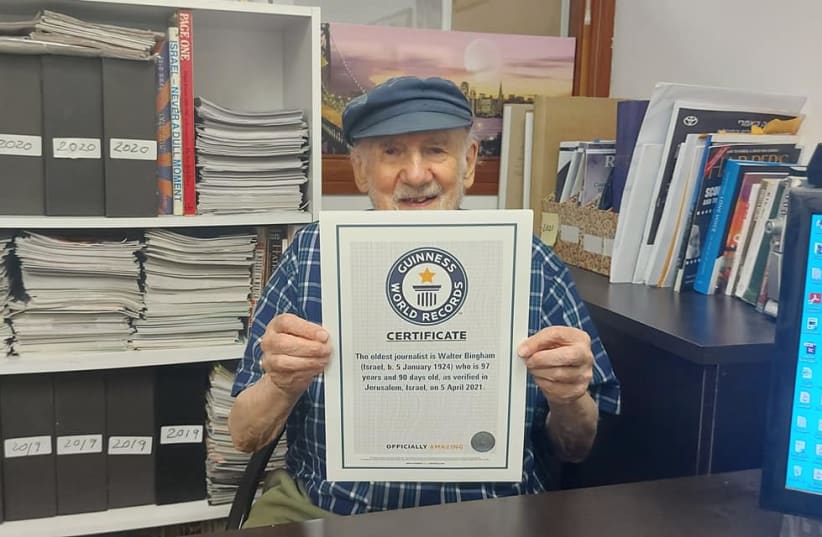 Walter Bingham holds up the certificate acknowledging his record as the oldest journalist in the world during a visit to ‘The Jerusalem Report’ (photo credit: STEVE LINDE)