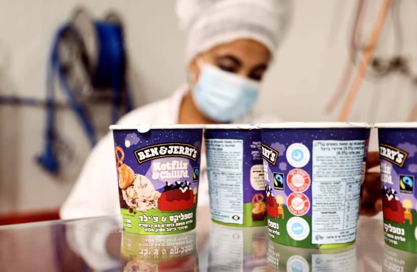 Tubs of ice-cream are seen as a labourer works at Ben & Jerry's factory in Be’er Tuviya, Israel July 20, 2021. (photo credit: REUTERS/RONEN ZEVULUN)