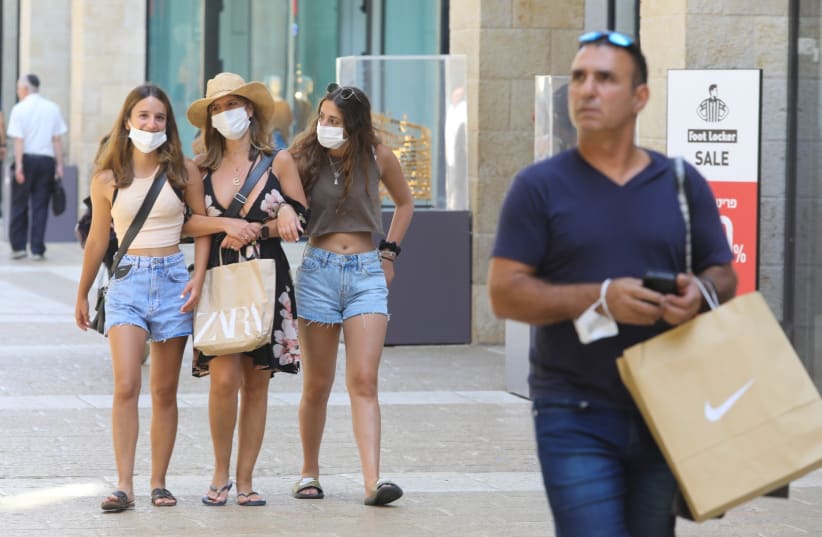Women shopping in Jerusalem with face masks amid the coronavirus pandemic (photo credit: MARC ISRAEL SELLEM)