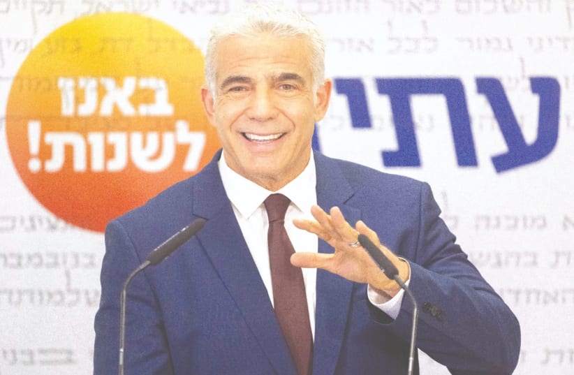 YESH ATID party head Yair Lapid speaks during a faction meeting at the Knesset earlier this week. (photo credit: YONATAN SINDEL/FLASH 90)