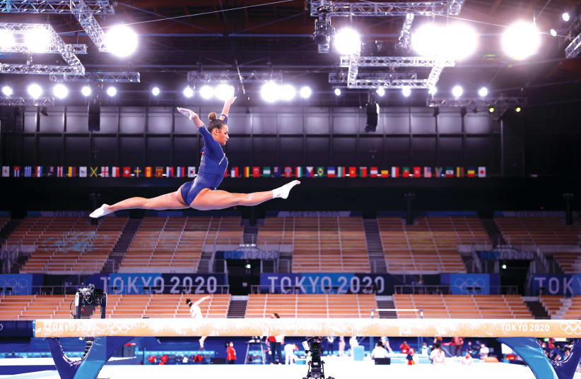 MARINE BOYER of France trains on the balance beam during training in Tokyo yesterday. (photo credit: MIKE BLAKE/ REUTERS)
