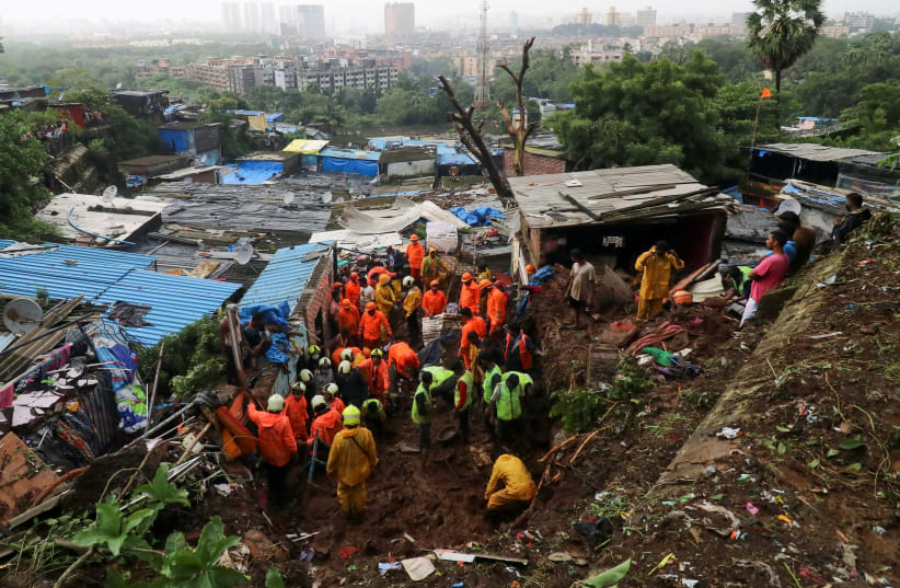 Rescue workers search for survivors after house collapse due to landslide in Mumbai (photo credit: REUTERS/NIHARIKA KULKARNI/FILE PHOTO)