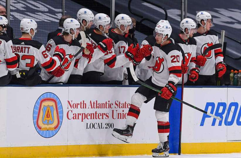 ew Jersey Devils center Michael McLeod (20) celebrates his goal with the bench of the New Jersey Devils against the New York Islanders during the second period at Nassau Veterans Memorial Coliseum. (photo credit: REUTERS)