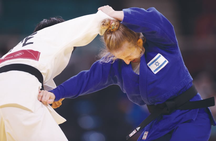 ISRAELI JUDOKA Shira Rishony competes against Taiwan’s Lin Chen-hao, forced to wear the TPE tag for Chinese Taipei. (photo credit: HANNAH MCKAY/ REUTERS)