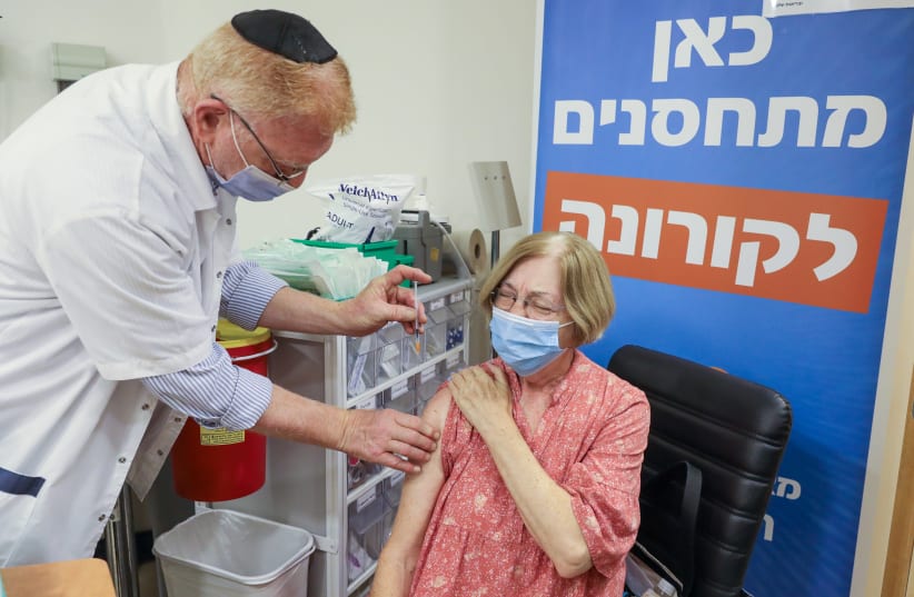 Jerusalem resident Klara Brieff is seen getting the third COVID-19 vaccine at a Meuhedet clinic, on August 1, 2021. (photo credit: MARC ISRAEL SELLEM/THE JERUSALEM POST)